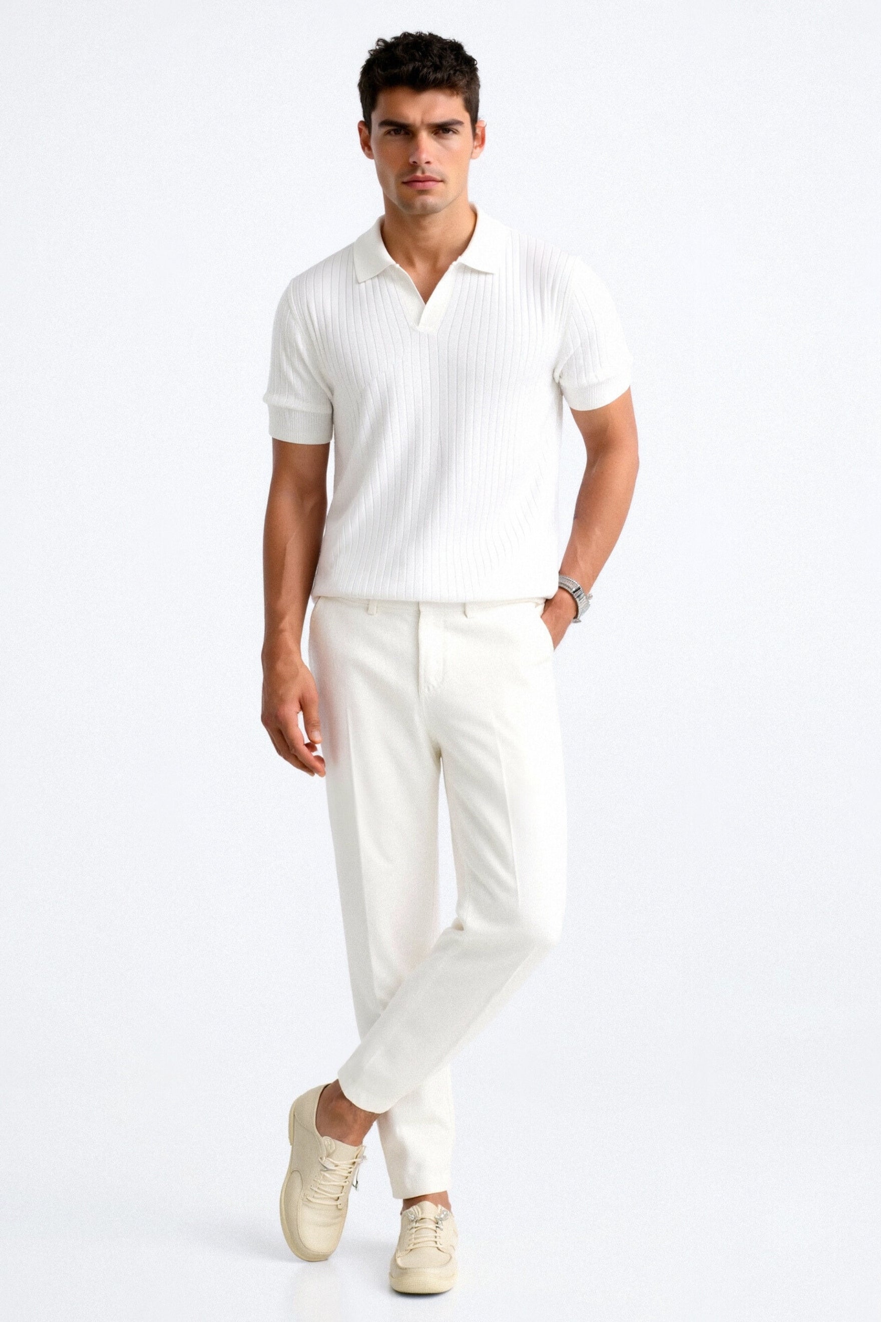 Man wearing a white polo shirt and pants on a white background
