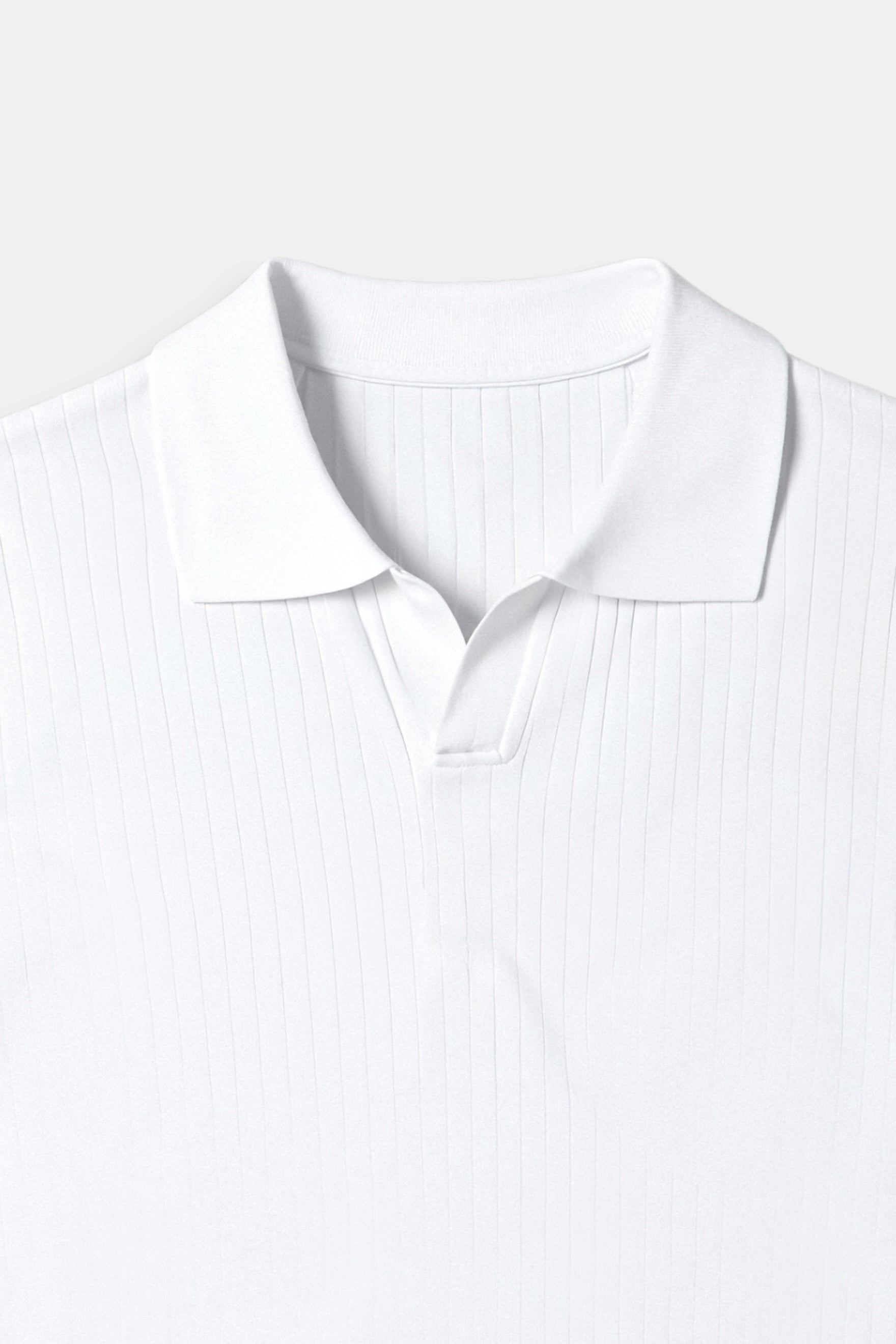 Close-up of a white shirt collar on a light gray background