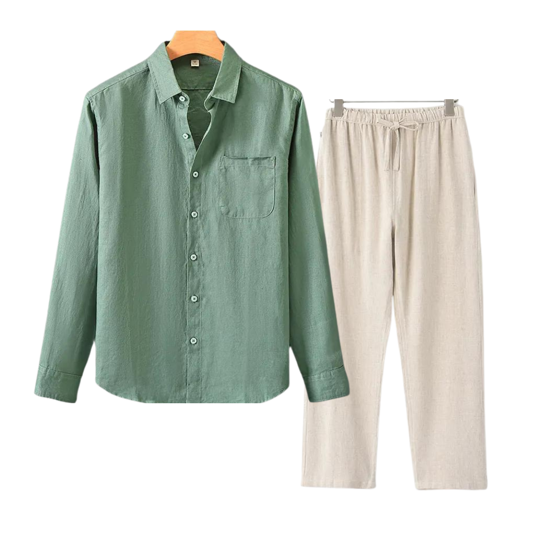 Green shirt and beige pants on hangers against a white background