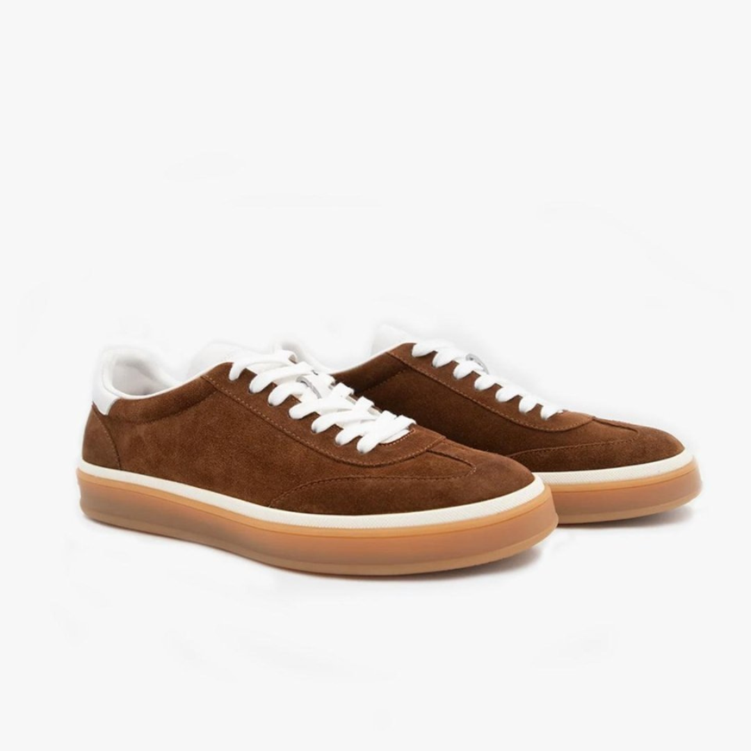 Brown sneakers with white laces and soles on a white background