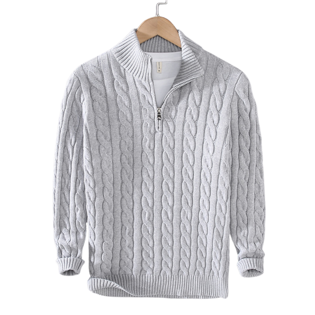 Gray cable knit sweater with a quarter zip on a hanger against a white background