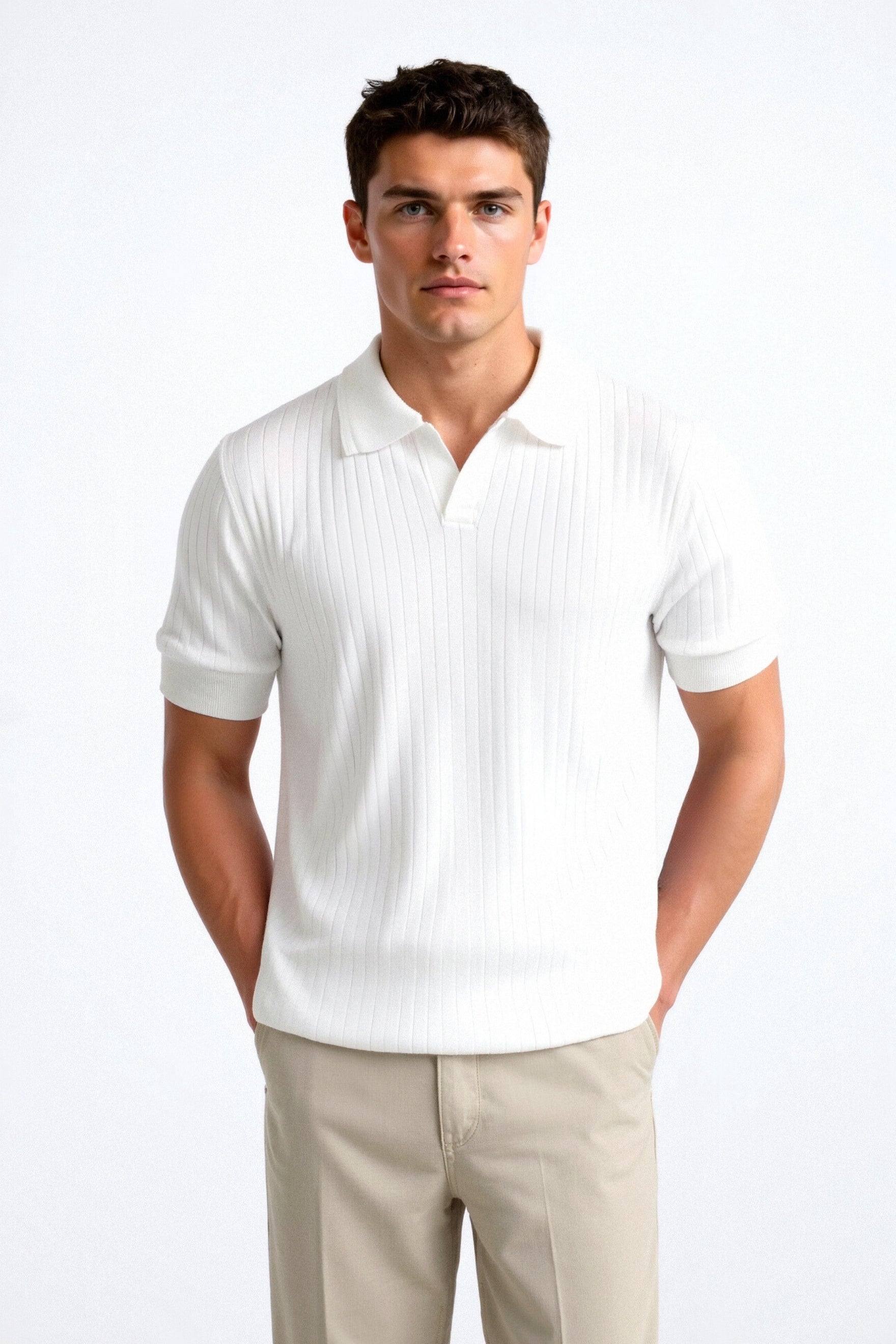 Man wearing a white polo shirt and beige pants on a white background